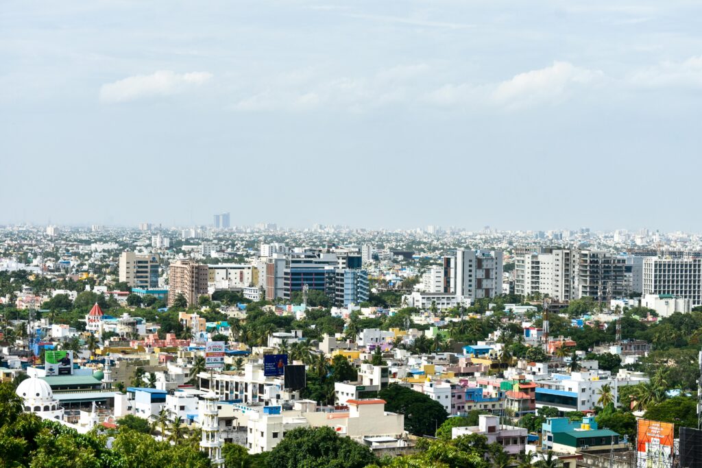 Aerial view of colorful high-rise buildings in Chennai, India, under a clear sky.